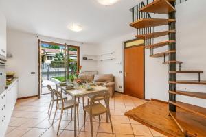 a kitchen and dining room with a table and chairs at Juliette House: Shared Pool & Relax - Happy Rentals in Salò