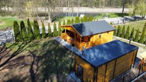 a small house with a blue roof in a yard at Zacisze domek z Jacuzzi & Sauna in Chrołowice