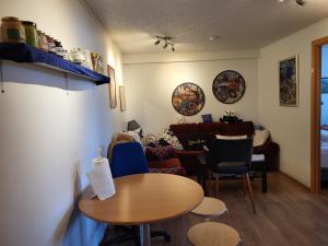 a living room with a table and a couch at Holiday Guesthouse in Stykkishólmur
