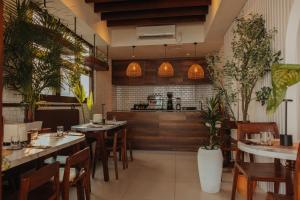 a restaurant with tables and chairs and a kitchen at Hotel Amber Seaside in Hulhumale