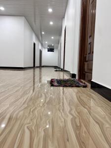 a room with a wooden floor with a yoga mat on the floor at UK Villa & Guest house in Jaffna