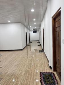 an empty room with a hallway with a rug on the floor at UK Villa & Guest house in Jaffna