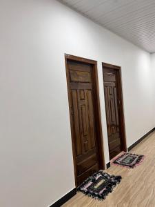 an empty room with two wooden doors on a wall at UK Villa & Guest house in Jaffna