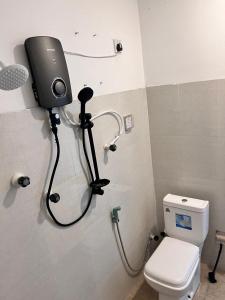 a shower in a bathroom with a toilet at UK Villa & Guest house in Jaffna