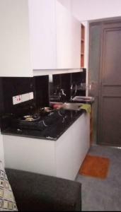 a kitchen with a black and white counter top at Tembea Stays in Kiambaa
