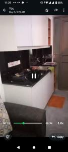 a kitchen with a black and white stove top oven at Tembea Stays in Kiambaa