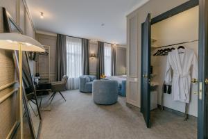 a hotel room with a robe hanging on a door at King Gorgasali in Tbilisi City +99 photos