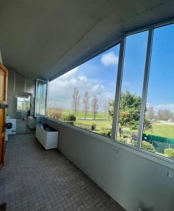 an empty room with a large window in a building at Casa Ariel in Lido Adriano