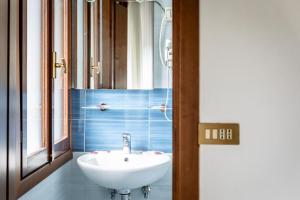 a bathroom with a sink and a mirror at Hotel Oasi Verde in Lido di Jesolo +22 photos