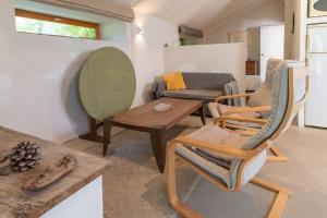a living room with a couch and a table and chairs at La Terrasse in Patrimonio