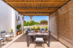 a patio with a table and chairs and a brick wall at Corte Dei Saraceni - Lecce Selection in Lecce