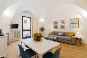 a living room with a table and a couch at Corte Dei Saraceni - Lecce Selection in Lecce