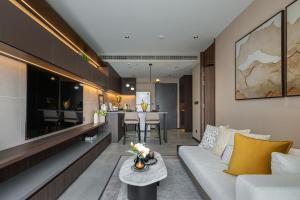 a living room with a couch and a table at The Panora Estuaria Pattaya in Na Jomtien