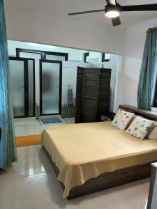 a bedroom with a bed in a room with windows at Serenity Apartments in Albion