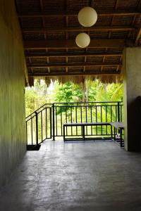 a room with a balcony with a bench on it at yolked suites in General Luna