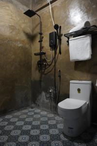 a bathroom with a toilet and a shower at yolked suites in General Luna