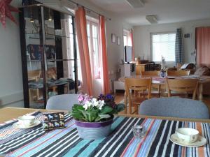 a dining room table with a vase of flowers on it at Relax House Rättvik Spa Nordic in Rättvik