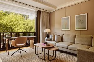 a living room with a couch and a table at The Emory, Maybourne in London