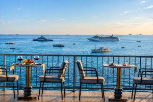 a balcony with tables and chairs and boats in the water at Ayasofya Hotel - Special Class in Istanbul +100 photos