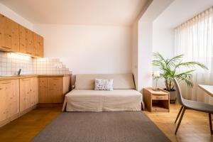 a living room with a couch and a table at Residence Walder in Falzes
