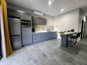 an empty kitchen with a table and a refrigerator at Nonaka in Louis Trichardt +21 photos