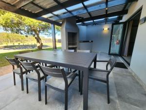 a dining room table and chairs on a patio at Nonaka in Louis Trichardt
