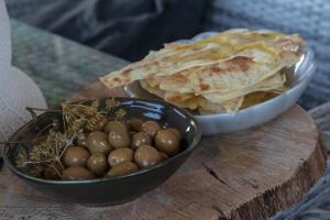 two bowls of food on a wooden cutting board at Bentu Boutique Apartment in San Nicolò Gerrei