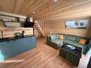 a large living room with a couch and a kitchen at Cozy Home Kazbegi in Kazbegi