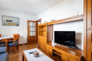 a living room with a large flat screen tv at Apartamento Río do Con Vilagarcía in Vilagarcia de Arousa