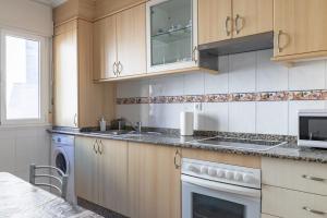 a kitchen with a sink and a dishwasher at Apartamento Río do Con Vilagarcía in Vilagarcia de Arousa +12 photos
