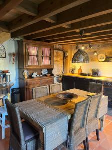 a kitchen with a wooden table and chairs at Dão country house in Silgueiros