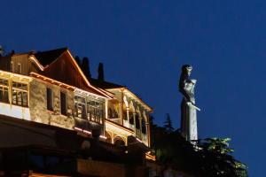 a statue of a woman standing on top of a building at King Gorgasali in Tbilisi City