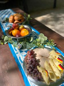 a table with two plates of cheese and fruit at Munich Oktoberfest Central Camping Village in Munich