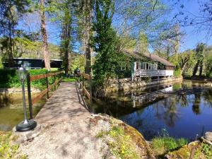 a house with a dock next to a river at Le rêve au fil de l'eau in Marmagne +8 photos