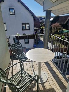 a table and two chairs and a table on a balcony at Hotel Restaurant Yiamas in Breitenworbis