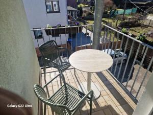a table and two chairs and a table on a balcony at Hotel Restaurant Yiamas in Breitenworbis +12 photos