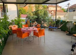 a patio with a table and chairs on a balcony at Private Room & Terrace in Skopje