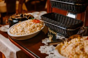 a table with a bowl of food and a basket at Hotel Elenka in Veľký Meder +11 photos