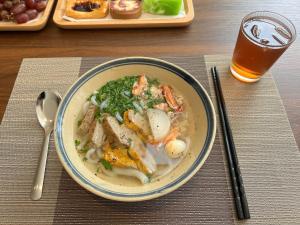 a bowl of food on a table with a drink at ANNA Boutique Villa - Sea View in Phan Thiet