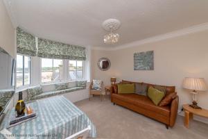 a living room with a couch and a bed at Bass Rock View in North Berwick