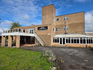 a large brick building with a ramp in front of it at The Paddington House in Warrington