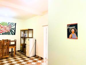 a kitchen with a refrigerator and a table at Bee Rooms Nosy be in Ambatoloaka +17 photos