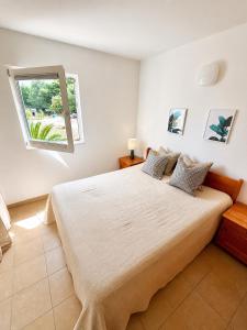 a bedroom with a large bed with a window at Mirca by the Sea in Mirce