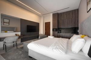 a bedroom with a white bed and a desk at 108 Opebi Executive Apartments in Lagos +2 photos
