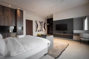 a bedroom with a white bed and a television at 108 Opebi Executive Apartments in Lagos