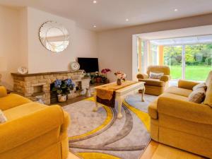 a living room with yellow furniture and a fireplace at 2 Bed in Wareham oc-75483 in Corfe Castle