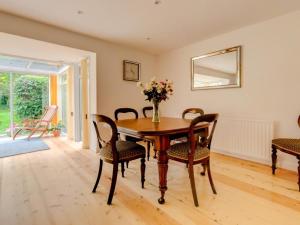 a dining room with a wooden table and chairs at 2 Bed in Wareham oc-75483 in Corfe Castle +2 photos