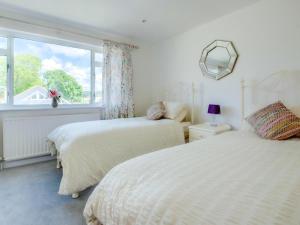 two beds in a bedroom with a window at 2 Bed in Wareham oc-75483 in Corfe Castle