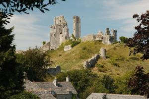 a castle on top of a hill with houses at 2 Bed in Wareham oc-75483 in Corfe Castle
