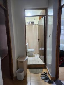 a bathroom with a shower and a toilet and a mirror at Zariah Homes 1 in Kakamega